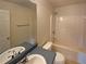 Full bathroom with tiled shower over tub, single vanity, and tile floors at 40 Zebulon Pl, Covington, GA 30016