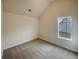 Cozy bedroom with carpeted floor, large window, and vaulted ceilings at 40 Zebulon Pl, Covington, GA 30016