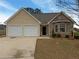 Charming single-Gathering home featuring a two-car garage, stone accents, and mature landscaping in a suburban neighborhood at 40 Zebulon Pl, Covington, GA 30016