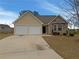 Charming single-Gathering home with stone accents, a two-car garage, and a well-maintained lawn at 40 Zebulon Pl, Covington, GA 30016