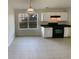 Kitchen has tile flooring, white cabinets and modern black appliances with eat in breakfast area at 40 Zebulon Pl, Covington, GA 30016