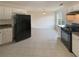 Spacious kitchen boasts white cabinets, black appliances, and tile flooring with plenty of room at 40 Zebulon Pl, Covington, GA 30016