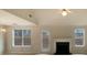 Bright living room featuring a fireplace, neutral walls, and large windows offering natural light at 40 Zebulon Pl, Covington, GA 30016