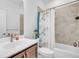 Bathroom featuring a vanity with dark wood cabinets and a tub and shower with decorative curtain at 163 Lorraine Pkwy, Woodstock, GA 30188