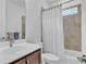 Bathroom featuring a vanity with dark cabinets and a tub and shower with tile surround at 163 Lorraine Pkwy, Woodstock, GA 30188
