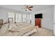 Bedroom featuring a ceiling fan, large windows, and a dark wood dresser at 163 Lorraine Pkwy, Woodstock, GA 30188
