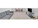 Bonus room with a comfortable sofa and entertainment center with mounted TV at 163 Lorraine Pkwy, Woodstock, GA 30188