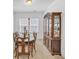 Bright dining room featuring stylish wooden table, chairs, and display cabinet at 163 Lorraine Pkwy, Woodstock, GA 30188