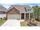 Charming brick home with a well-manicured lawn, garage, and inviting front porch at 163 Lorraine Pkwy, Woodstock, GA 30188