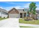 Charming brick home with a two-car garage, manicured lawn, and inviting front entrance at 163 Lorraine Pkwy, Woodstock, GA 30188