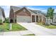 Traditional brick home with a two-car garage, and a landscaped front yard at 163 Lorraine Pkwy, Woodstock, GA 30188