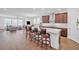 Open-concept kitchen with bar, leading to a dining and living area, creating a spacious and social atmosphere at 163 Lorraine Pkwy, Woodstock, GA 30188