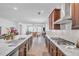 Bright kitchen featuring granite countertops, stainless steel appliances, and an open layout to the living area at 163 Lorraine Pkwy, Woodstock, GA 30188