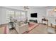 Inviting living room with large windows, a comfortable sofa, and hardwood floors at 163 Lorraine Pkwy, Woodstock, GA 30188