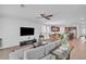 Open concept living room and kitchen with hardwood floors and ceiling fan at 163 Lorraine Pkwy, Woodstock, GA 30188