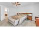 Comfortable main bedroom with ceiling fan, carpeted floor, and bathroom entrance at 163 Lorraine Pkwy, Woodstock, GA 30188
