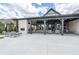 An outdoor covered patio area featuring a stone fireplace and comfortable seating at 163 Lorraine Pkwy, Woodstock, GA 30188