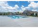 A community pool with lounge chairs under pergolas on a sunny day at 163 Lorraine Pkwy, Woodstock, GA 30188
