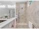 Bright bathroom shower with tiled walls, bench, handheld wand, and shower head at 163 Lorraine Pkwy, Woodstock, GA 30188