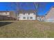 Large, grassy backyard features a home exterior, trees and a wood fence for privacy at 4047 Round Stone Trl, Snellville, GA 30039