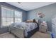 Bedroom features carpet, a large window, and light gray walls at 4047 Round Stone Trl, Snellville, GA 30039