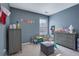 Cozy bedroom with two dressers, an ottoman, and a window with blinds providing natural light at 4047 Round Stone Trl, Snellville, GA 30039