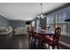 Bright dining room with hardwood floors, a large window, and a mahogany dining table at 4047 Round Stone Trl, Snellville, GA 30039