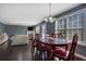 Bright dining room with hardwood floors, a large window, and a mahogany dining table at 4047 Round Stone Trl, Snellville, GA 30039