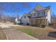 Charming two-story home features a two-car garage, white siding, blue shutters, and manicured landscaping at 4047 Round Stone Trl, Snellville, GA 30039