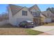 Charming two-story home features a two-car garage, white siding, blue shutters, and manicured landscaping at 4047 Round Stone Trl, Snellville, GA 30039