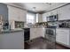 A view of a kitchen with gray counters, black appliances and a decorative backsplash at 4047 Round Stone Trl, Snellville, GA 30039