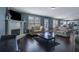 Spacious living room with hardwood floors, fireplace, large windows, and neutral-toned furniture at 4047 Round Stone Trl, Snellville, GA 30039