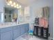 Well-lit bathroom featuring double vanity with ample counter space, a large mirror, and linen storage at 4047 Round Stone Trl, Snellville, GA 30039
