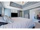 Spacious main bedroom with light gray walls and carpet, a decorative ceiling, and a large window at 4047 Round Stone Trl, Snellville, GA 30039