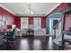 A home office has natural light, multiple desk, and dark wood floors throughout the first floor at 4047 Round Stone Trl, Snellville, GA 30039