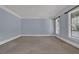 A bright and airy bedroom with neutral carpet and two windows at 4330 Old Oak Trce, Cumming, GA 30041