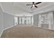 A spacious bedroom with neutral carpet, trey ceilings, and a ceiling fan with many windows at 4330 Old Oak Trce, Cumming, GA 30041
