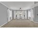Spacious room with carpeted flooring, recessed lights, and many windows with sheer curtains at 4330 Old Oak Trce, Cumming, GA 30041