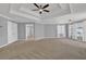 Spacious bedroom showcasing trey ceilings, a ceiling fan, neutral carpet, and many windows at 4330 Old Oak Trce, Cumming, GA 30041