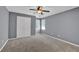 Bedroom with carpet flooring, neutral walls, ceiling fan, and a closet at 4330 Old Oak Trce, Cumming, GA 30041