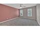 Large bedroom with a light accent wall, carpet flooring, and plenty of natural light at 4330 Old Oak Trce, Cumming, GA 30041