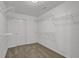 Walk-in closet with white walls and shelving, carpeted floors and a white door at 4330 Old Oak Trce, Cumming, GA 30041