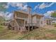 Back of house with multiple levels, decks, patios, and a well-maintained lawn at 4330 Old Oak Trce, Cumming, GA 30041
