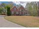 Traditional two-story brick home showcasing a well-maintained lawn and covered entry at 4330 Old Oak Trce, Cumming, GA 30041