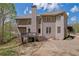 Back of house with multiple levels, decks, patios, and a well-maintained lawn at 4330 Old Oak Trce, Cumming, GA 30041