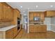 Well-equipped kitchen features wood cabinetry, tile backsplash, and stainless steel appliances at 4330 Old Oak Trce, Cumming, GA 30041