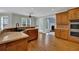 Open-concept kitchen featuring an island, wooden cabinets, and stainless steel appliances at 4330 Old Oak Trce, Cumming, GA 30041