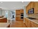 Modern kitchen with double ovens, wood cabinets, and a view of the living room at 4330 Old Oak Trce, Cumming, GA 30041