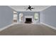 Spacious living room with large fireplace, arched windows and ceiling fan at 4330 Old Oak Trce, Cumming, GA 30041