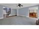 Open living room featuring hardwood floors, ceiling fan, and access to the kitchen at 4330 Old Oak Trce, Cumming, GA 30041